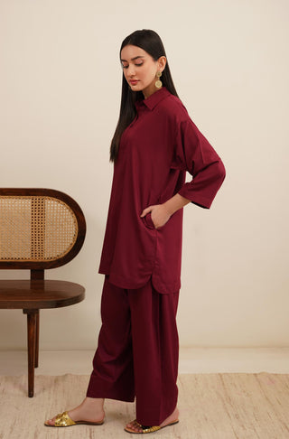 Side Shot of Raya Solid Red Co-ord set is made from ultra-soft wash and wear material featuring short shirt with collar and placket details and shalwar with relaxed fit